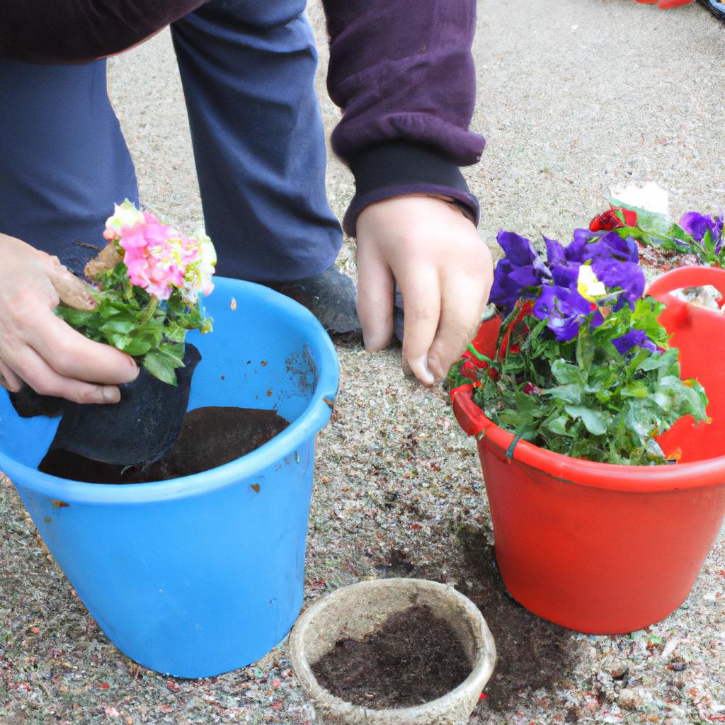 Person planting flowers in containers