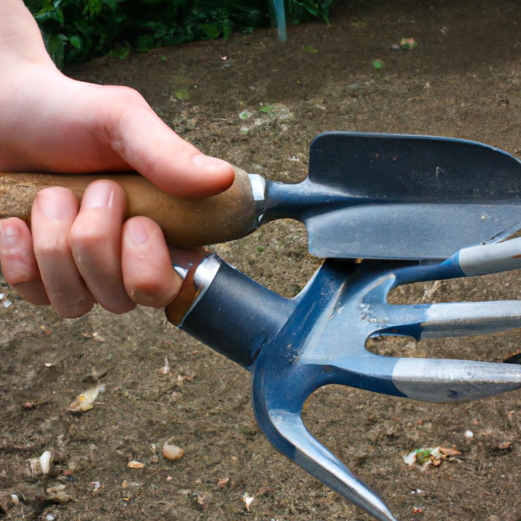 Person holding gardening tools, planting